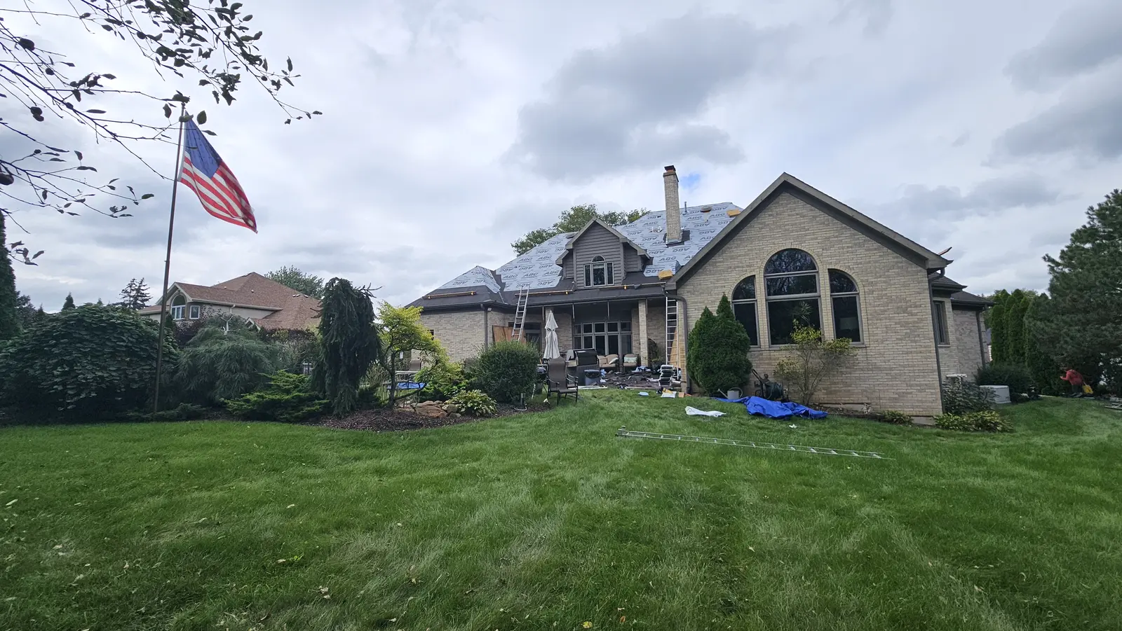 Restored home with an American flag in the front yard after exterior work